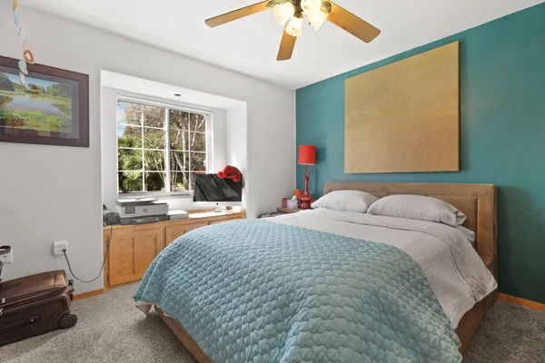 a bed sitting in a room next to a window