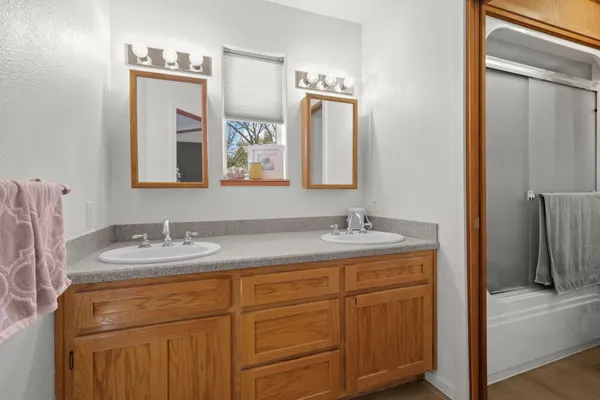 a bathroom with a granite countertop sink vanity and mirror