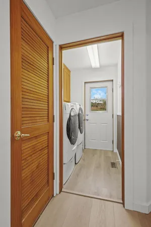 a view of a hallway with washer and dryer