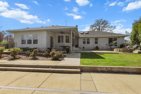 a front view of house with yard outdoor seating and green space