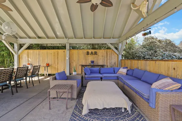 a living room with furniture a table and chairs