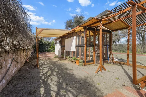 a view of a house with backyard and sitting area