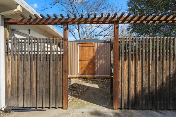 a view of a backyard with wooden fence