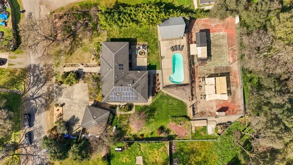an aerial view of residential houses with outdoor space