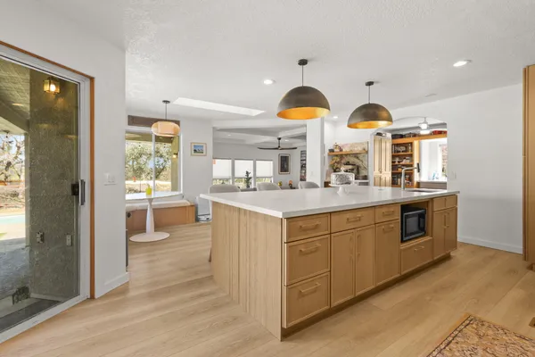 a kitchen with stainless steel appliances granite countertop a stove a sink and a refrigerator