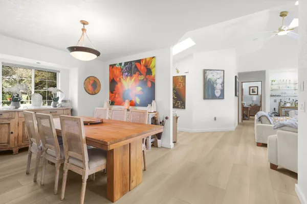 a view of a dining room with furniture and chandelier