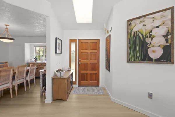 a view of an entryway with table and chair