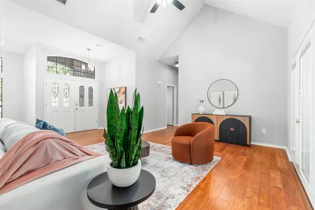 a bed room with furniture and a potted plant