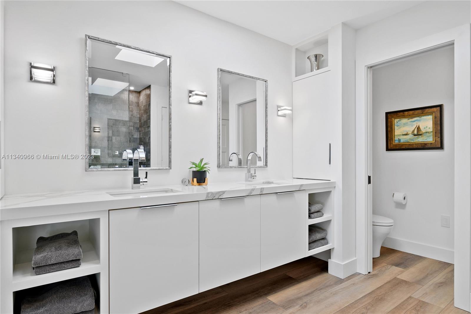 136 Sand Pine Drive Jupiter, FL 33477 - Photo 11 of 30 a spacious bathroom with a double vanity sink and a mirror