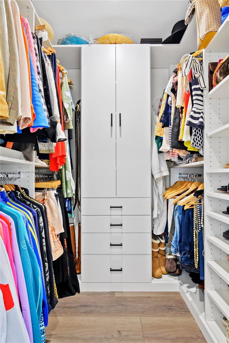 136 Sand Pine Drive Jupiter, FL 33477 - Photo 14 of 30 a view of walk in closet with clothes and shoes