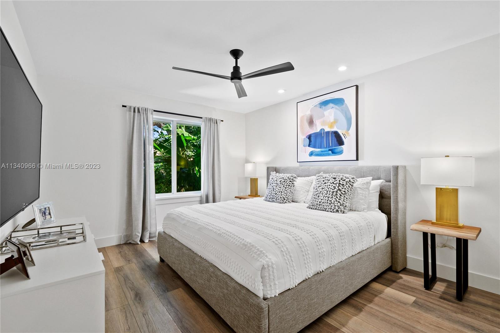 136 Sand Pine Drive Jupiter, FL 33477 - Photo 15 of 30 a bedroom with a large bed and a window