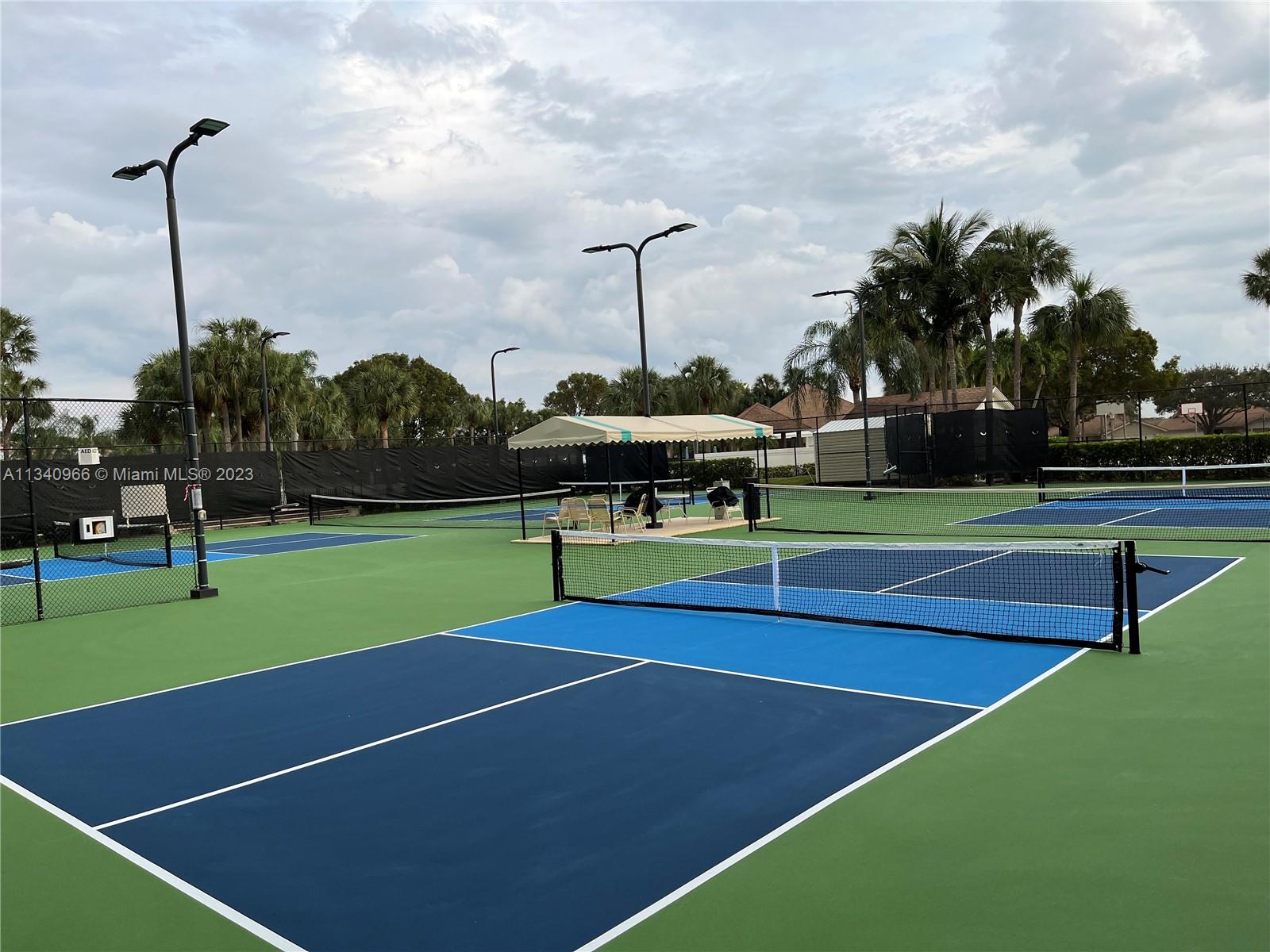 136 Sand Pine Drive Jupiter, FL 33477 - Photo 28 of 30 a tennis court with view of trees in the background