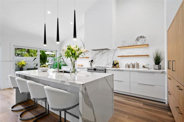 a kitchen with stainless steel appliances granite countertop a sink and a stove
