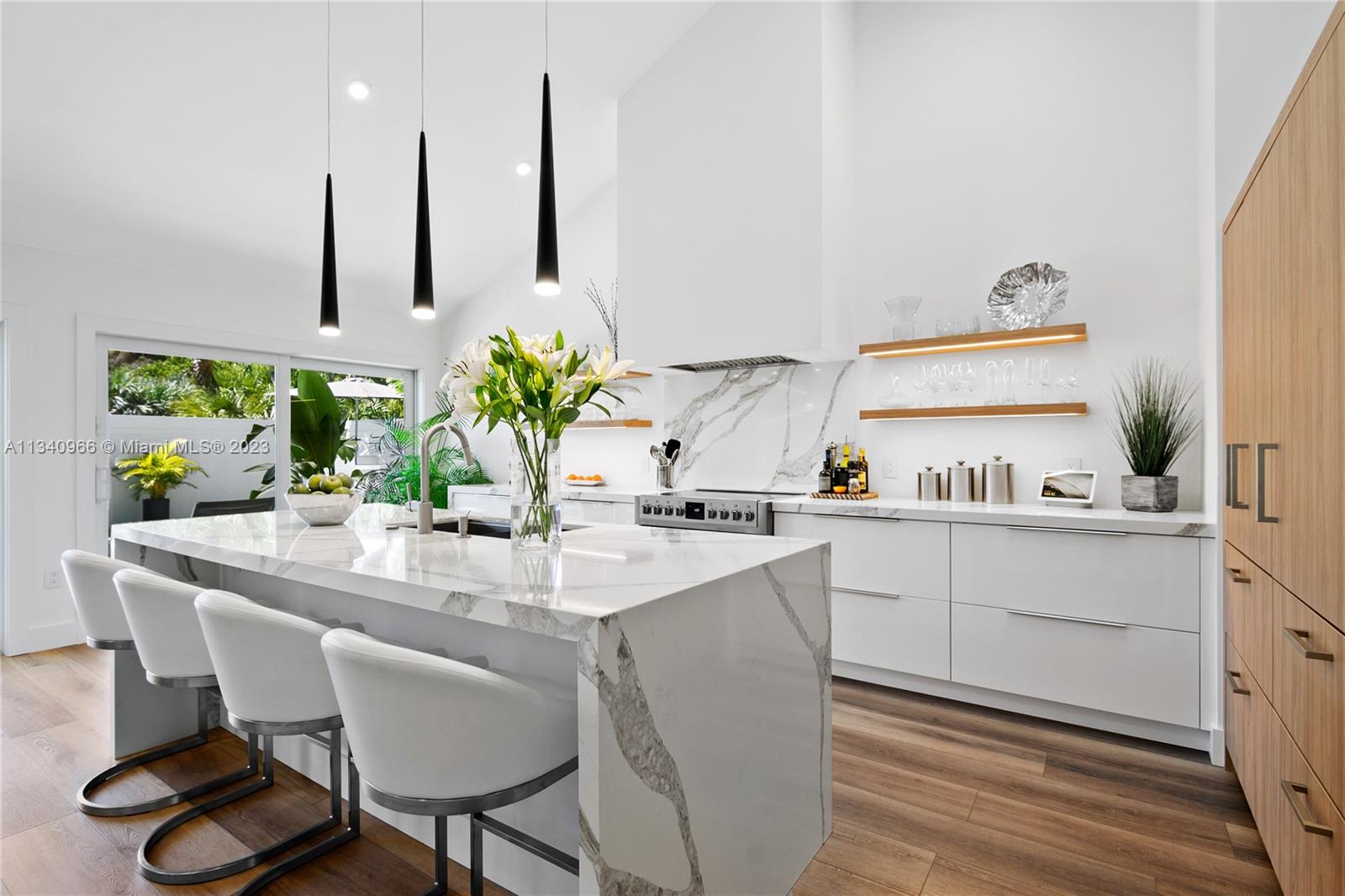 136 Sand Pine Drive Jupiter, FL 33477 - Photo 4 of 30 a kitchen with appliances cabinets and wooden floor
