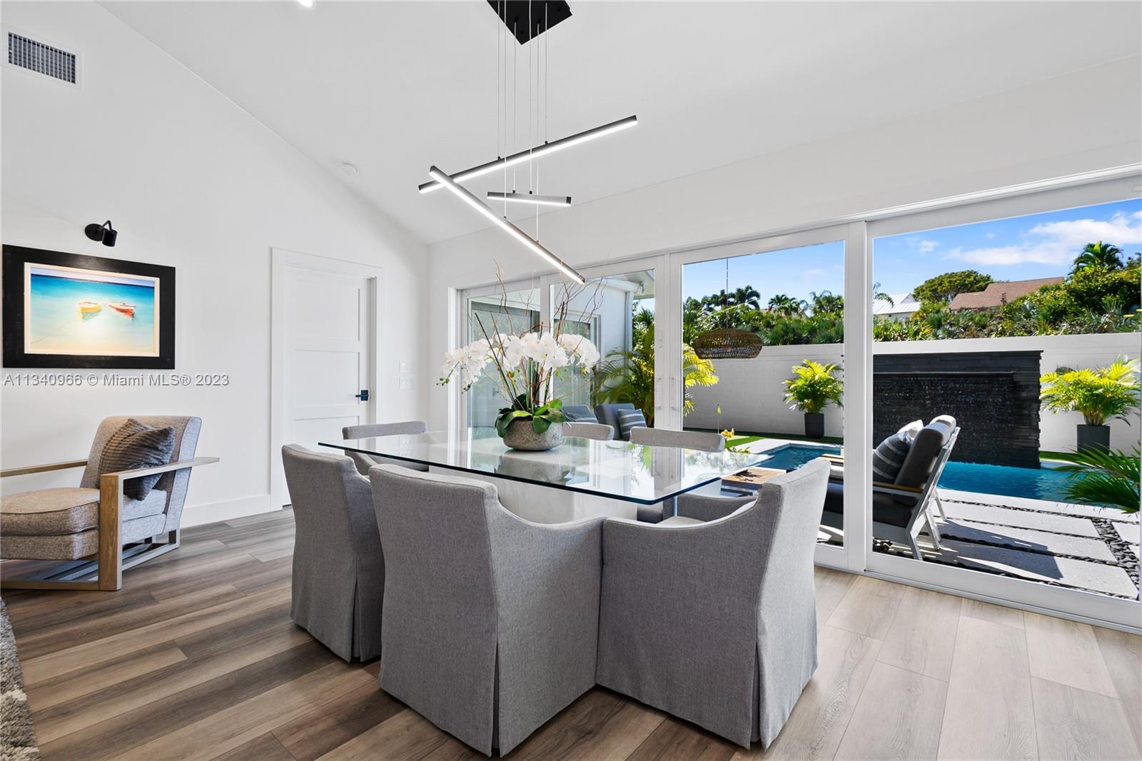 136 Sand Pine Drive Jupiter, FL 33477 - Photo 7 of 30 a living room with furniture a fireplace and a flat screen tv