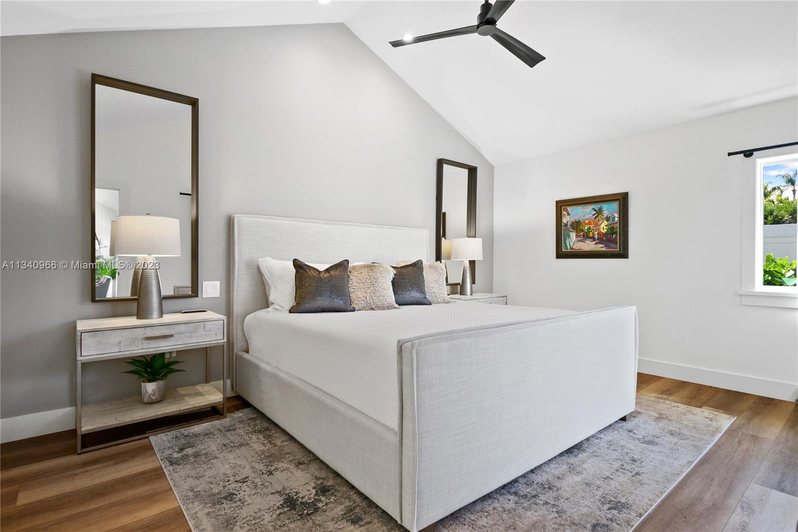 136 Sand Pine Drive Jupiter, FL 33477 - Photo 10 of 30 a bed room with a bed and a mirror