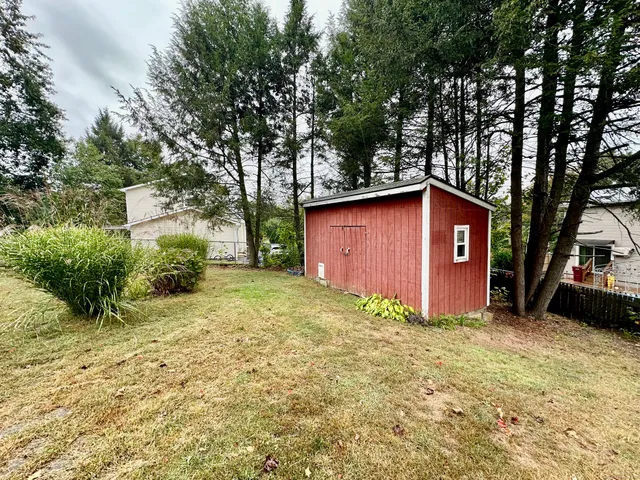 a large tree in front of a house