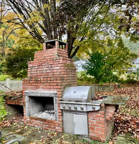 a view of a patio with table and chairs and a fire pit