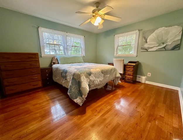 a bed sitting in a bedroom next to a window
