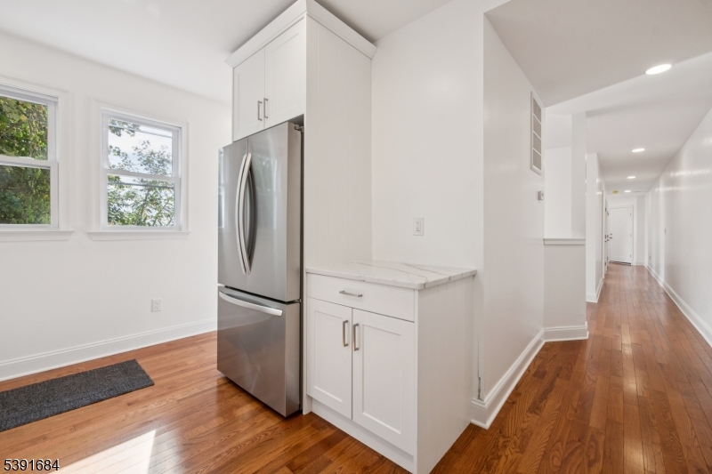 915 Main Street, Unit 2R Boonton, NJ 07005 - Photo 4 of 19 an empty room with wooden floor and a window