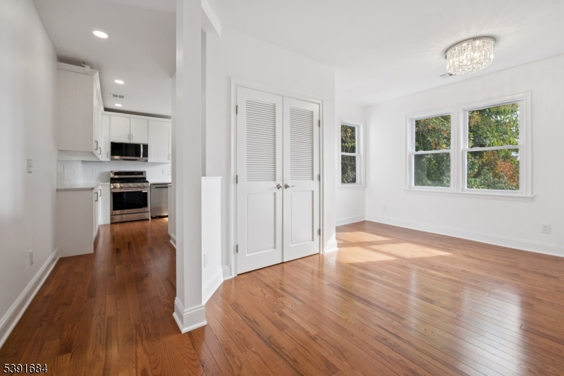 915 Main Street, Unit 2R Boonton, NJ 07005 - Photo 7 of 19 a view of a kitchen with wooden floor and a window