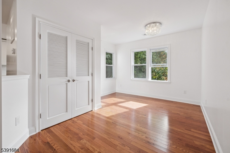 915 Main Street, Unit 2R Boonton, NJ 07005 - Photo 9 of 19 a view of an empty room with wooden floor and a window