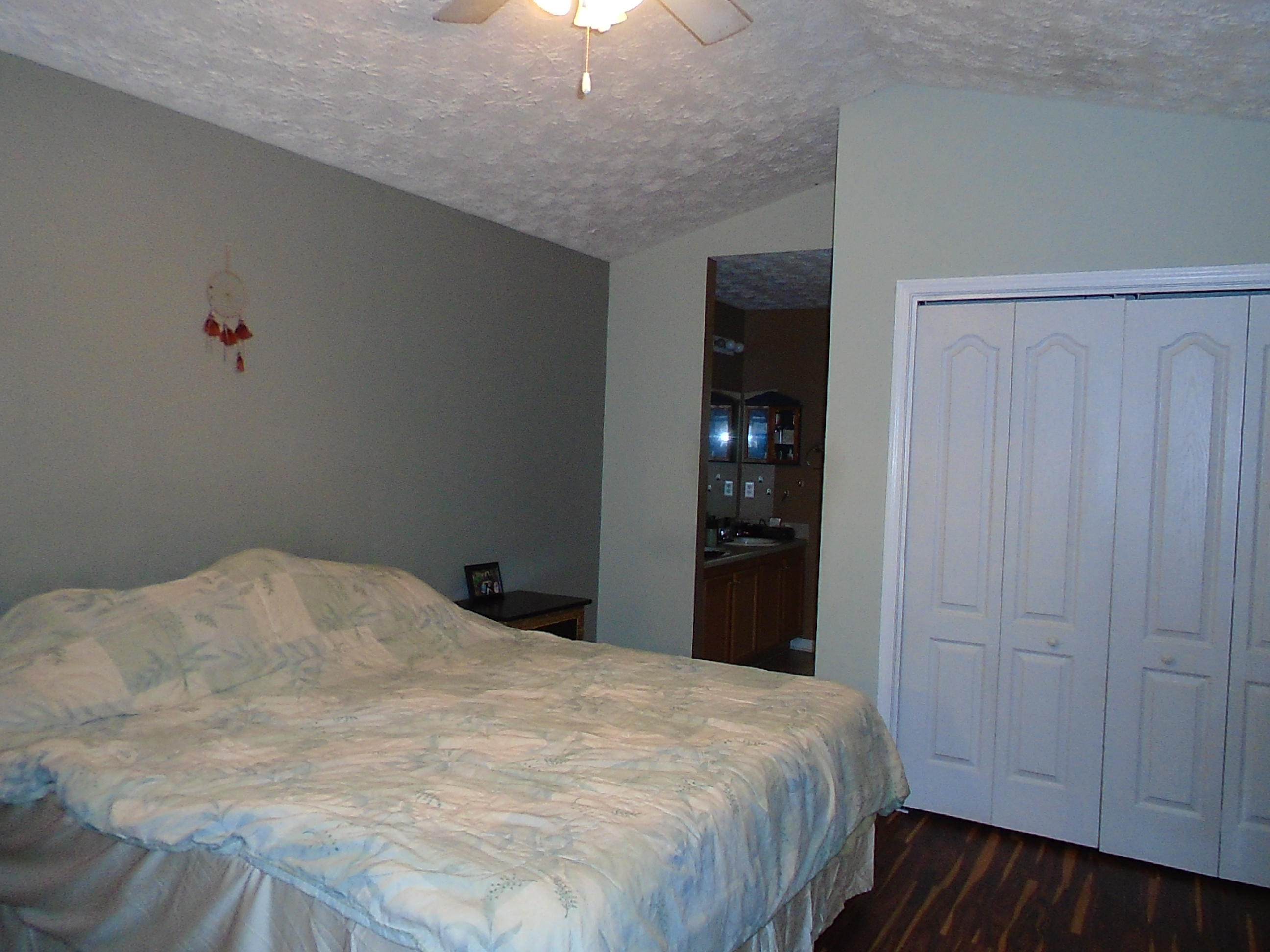 87 Tropical Way Freeport, FL 32439 - Photo 5 of 12 a bedroom with a bed and a chandelier fan