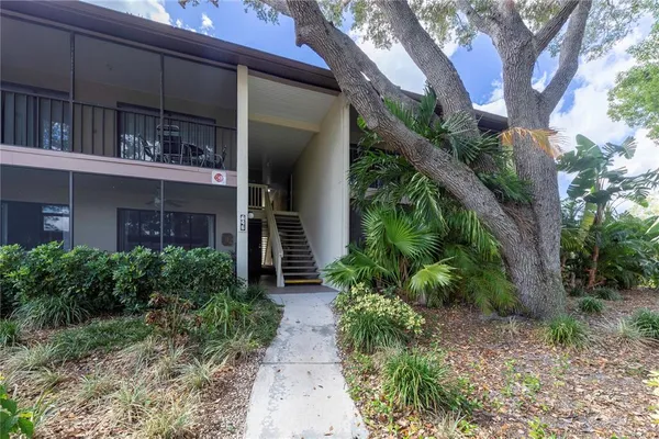 a view of a house with a plants next to a yard