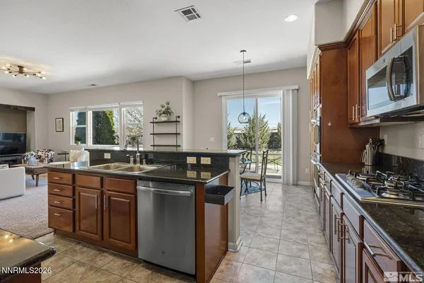 a kitchen with stainless steel appliances granite countertop a sink and cabinets