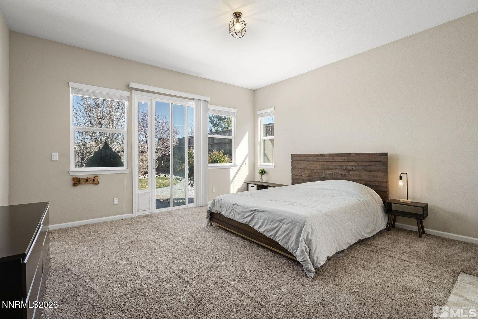 735 Sienna Park Drive Reno, NV 89512 - Photo 12 of 24 a bedroom with a large bed and a window