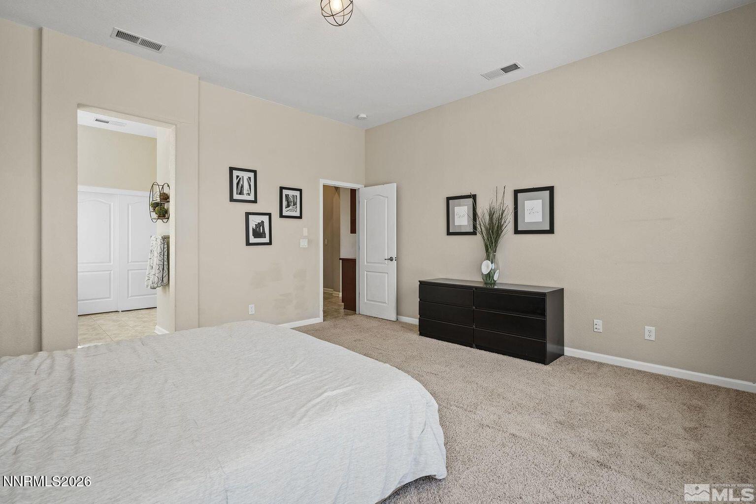 735 Sienna Park Drive Reno, NV 89512 - Photo 13 of 24 a bedroom with a bed and a chandelier