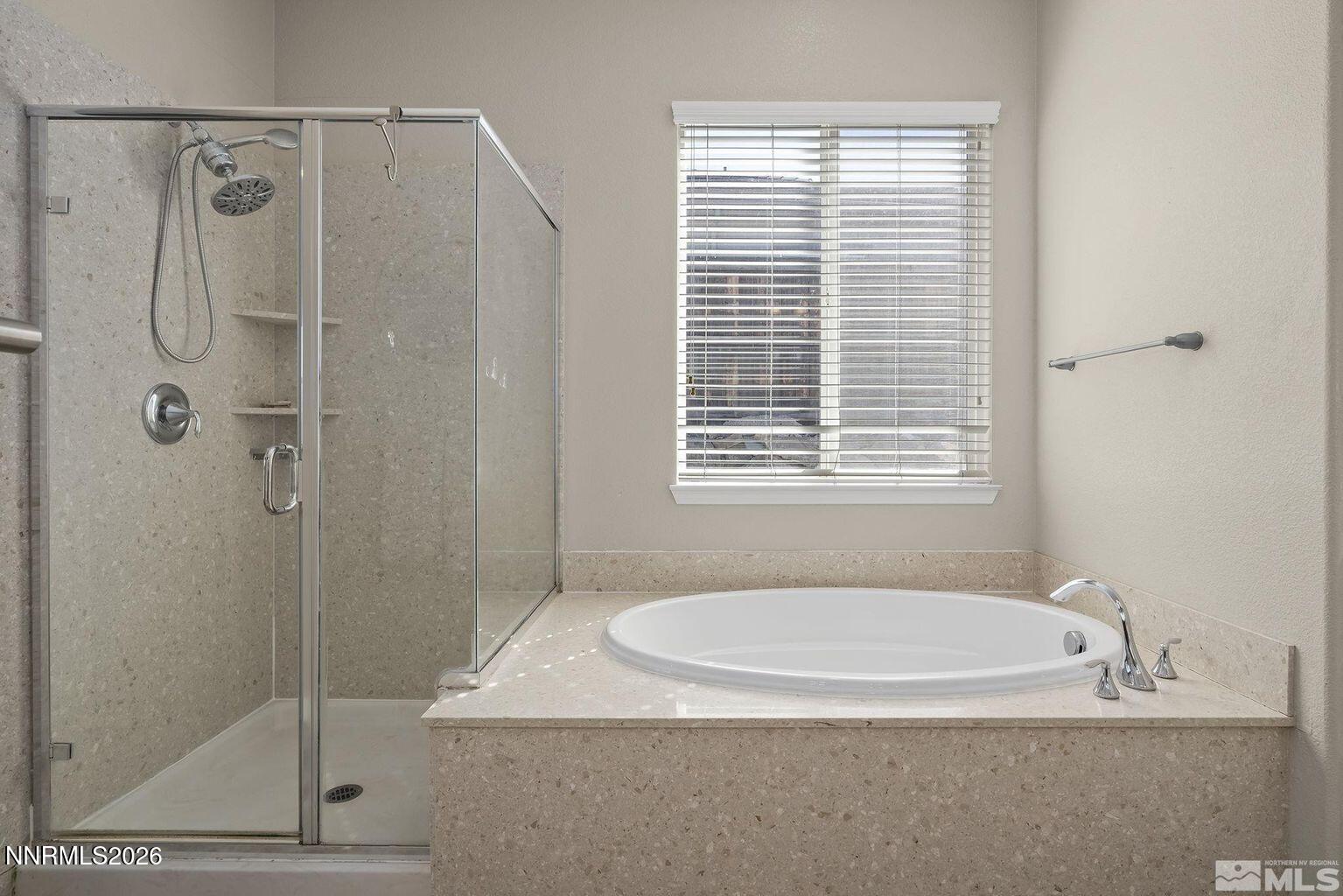 735 Sienna Park Drive Reno, NV 89512 - Photo 15 of 24 a bathroom with a granite countertop a shower a window and a sink