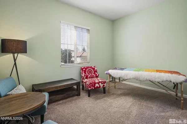 a bedroom with a bed and a chair