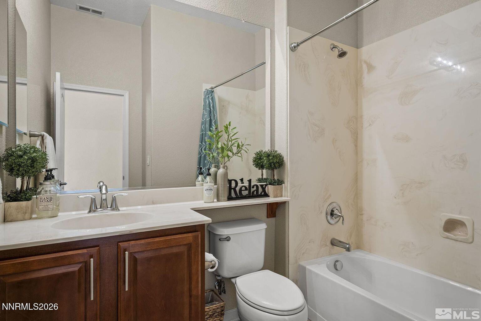 735 Sienna Park Drive Reno, NV 89512 - Photo 18 of 24 a bathroom with a granite countertop sink a toilet and shower