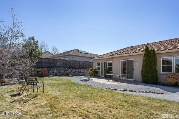 a view of a house with swimming pool and sitting area