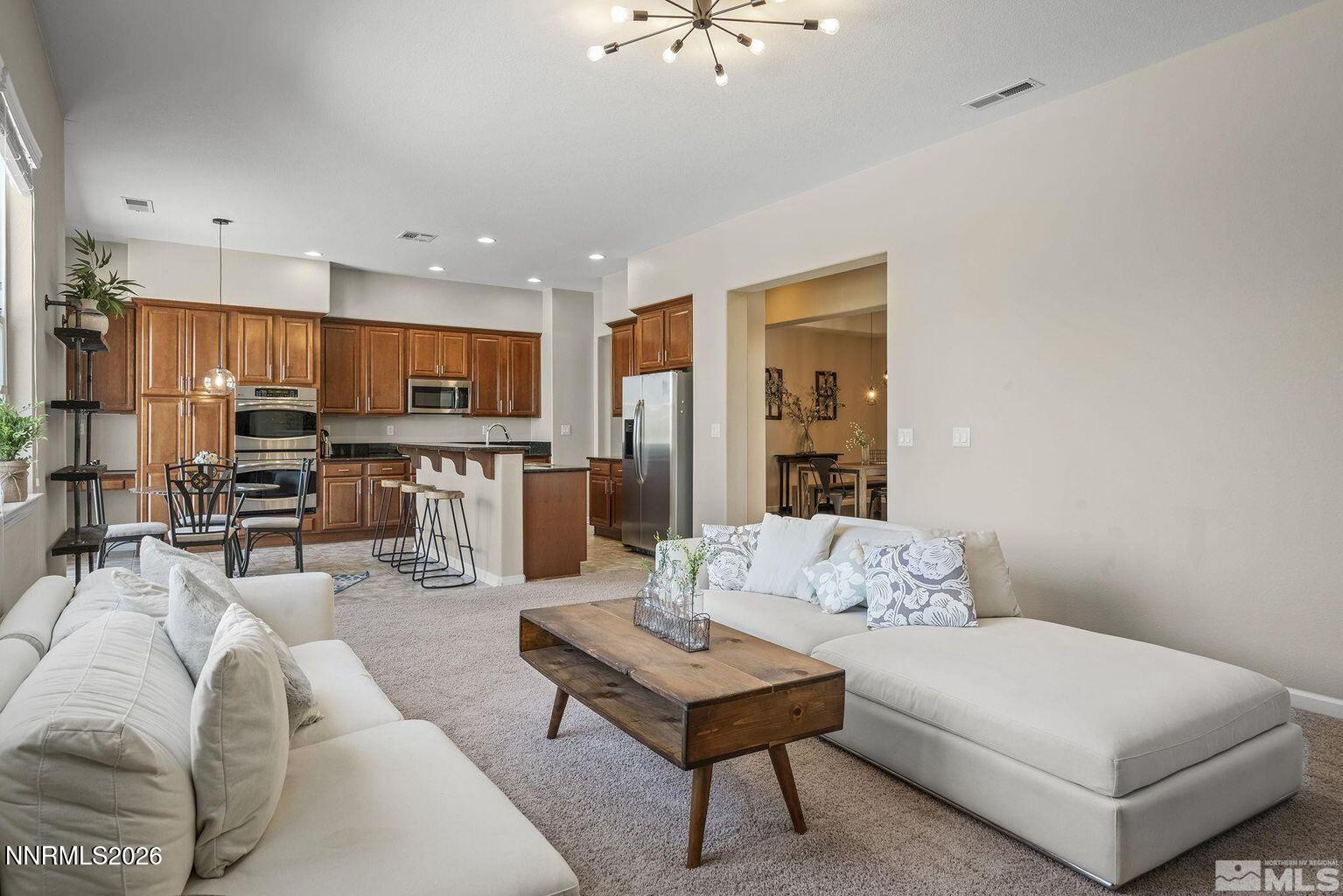 735 Sienna Park Drive Reno, NV 89512 - Photo 8 of 24 a living room with furniture a flat screen tv and kitchen view