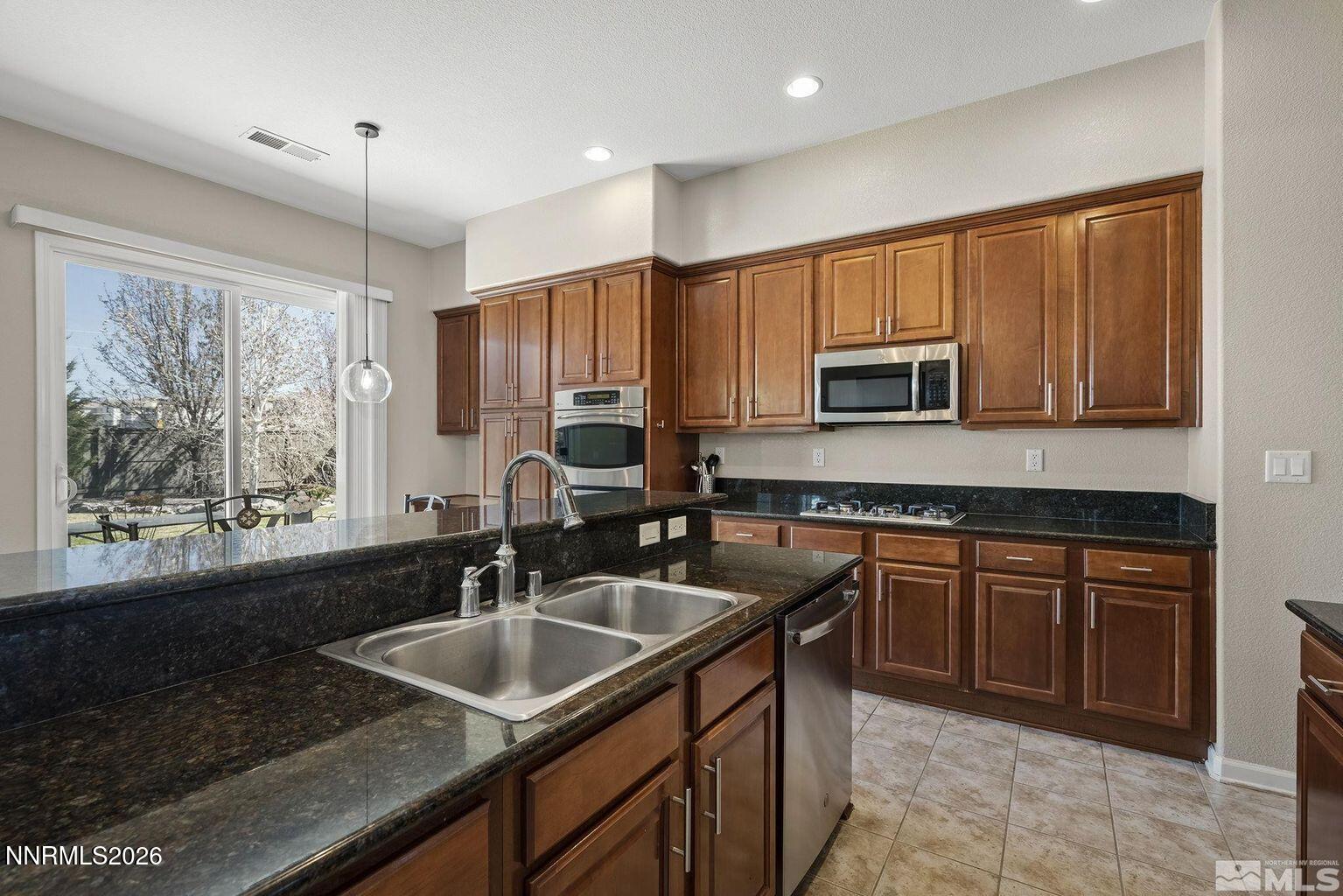 735 Sienna Park Drive Reno, NV 89512 - Photo 10 of 24 a kitchen with sink a window and appliances