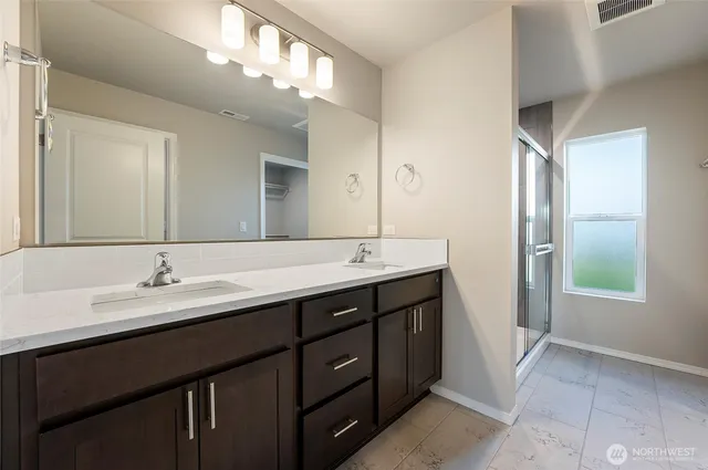 a bathroom with a double vanity sink and a mirror