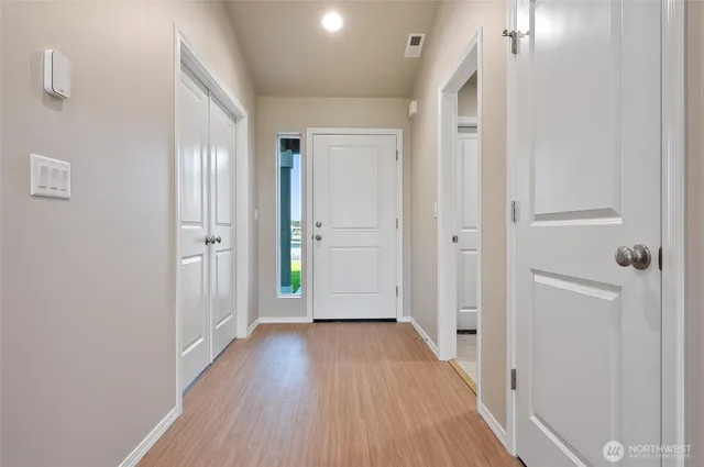 a view of hallway with wooden floor