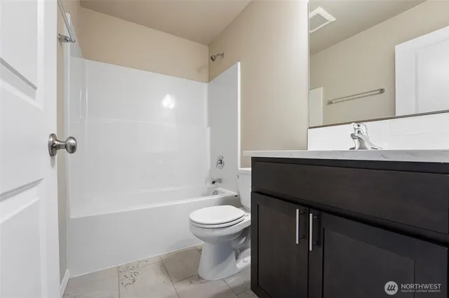 a bathroom with a sink a toilet a mirror and shower