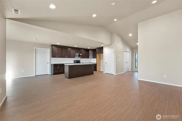 a view of kitchen with stainless steel appliances cabinets