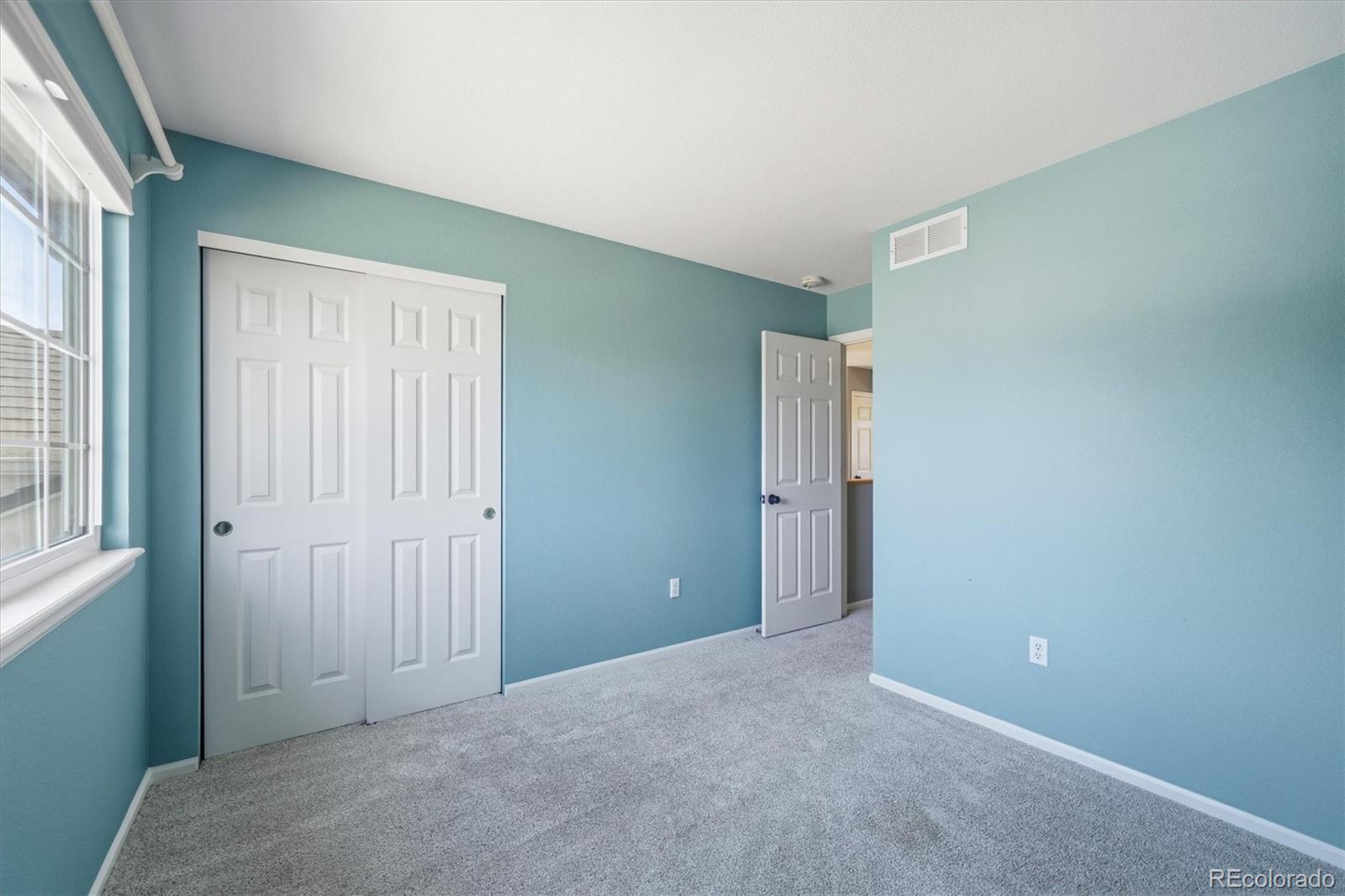 9629 Burberry Way Highlands Ranch, CO 80129 - Photo 31 of 50 an empty room with windows and closet