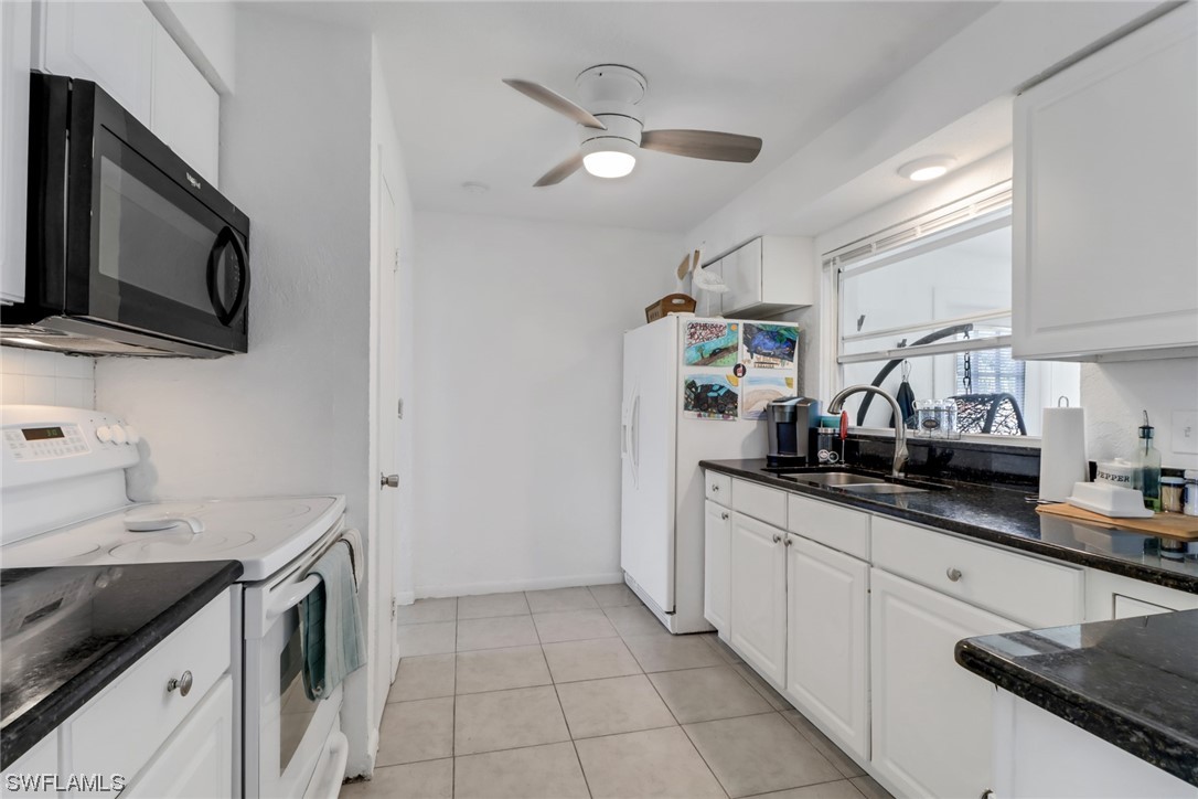 1192 Moody Road North Fort Myers, FL 33903 - Photo 12 of 29 a kitchen with granite countertop a sink stainless steel appliances and cabinets
