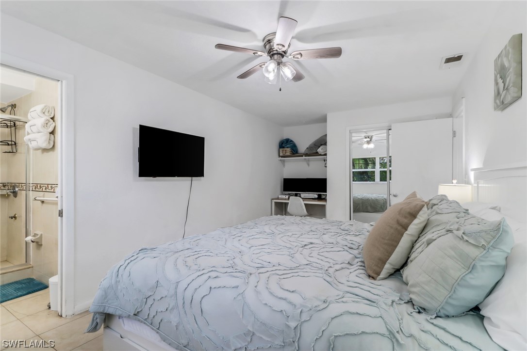 1192 Moody Road North Fort Myers, FL 33903 - Photo 18 of 29 a bedroom with a bed and a flat screen tv