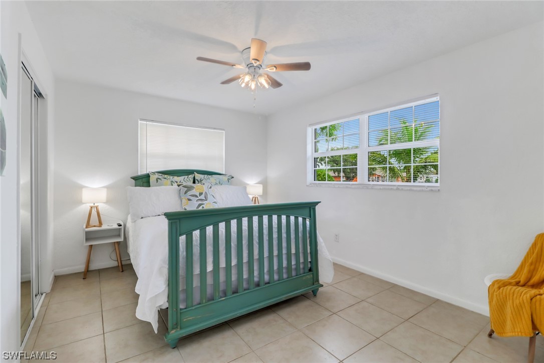 1192 Moody Road North Fort Myers, FL 33903 - Photo 20 of 29 a bedroom with a bed and a chandelier