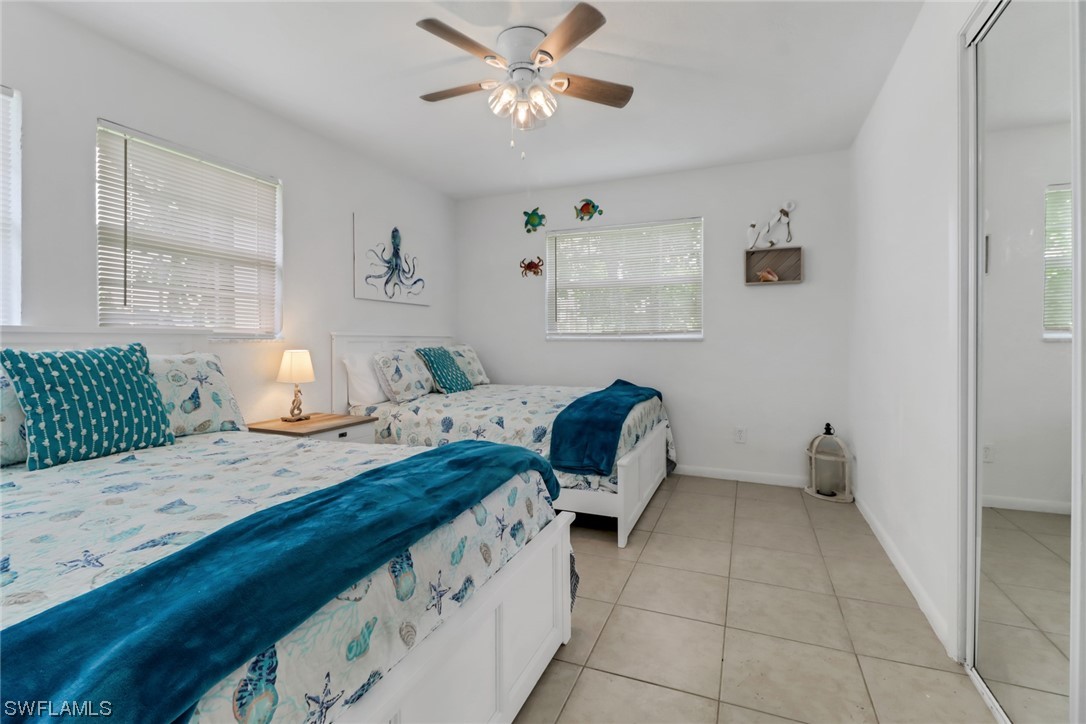 1192 Moody Road North Fort Myers, FL 33903 - Photo 23 of 29 a bedroom with a bed and a lamp on the dresser