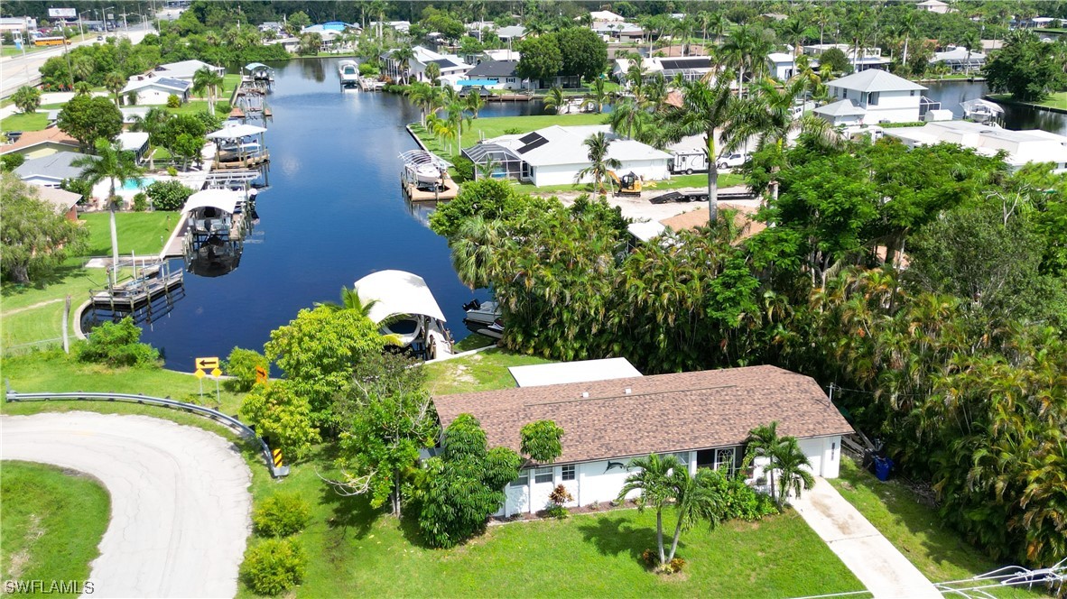 1192 Moody Road North Fort Myers, FL 33903 - Photo 26 of 29 a aerial view of a house with a yard and lake view