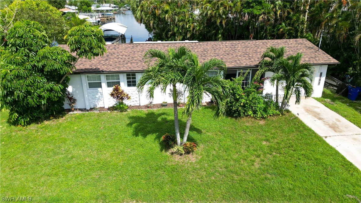 1192 Moody Road North Fort Myers, FL 33903 - Photo 28 of 29 a view of an house with backyard space and garden