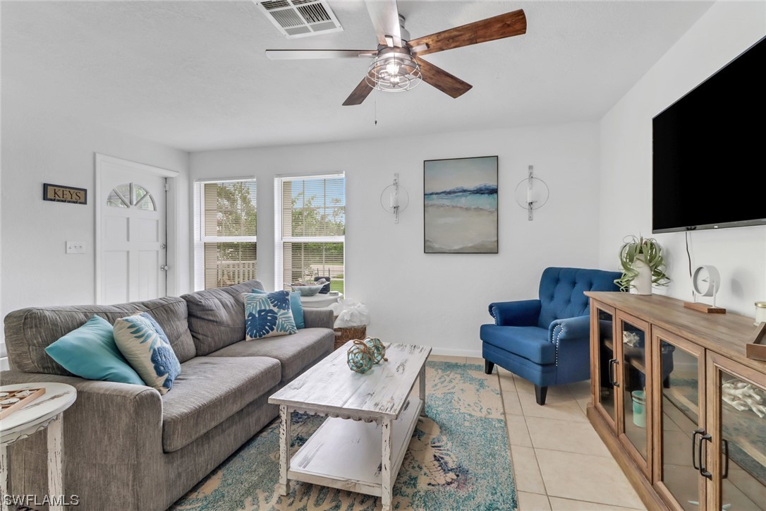 1192 Moody Road North Fort Myers, FL 33903 - Photo 4 of 29 a living room with furniture a flat screen tv and a window