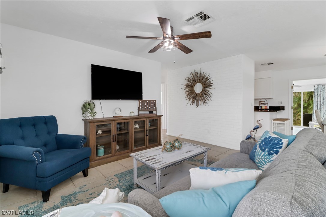 1192 Moody Road North Fort Myers, FL 33903 - Photo 7 of 29 a living room with furniture and a flat screen tv